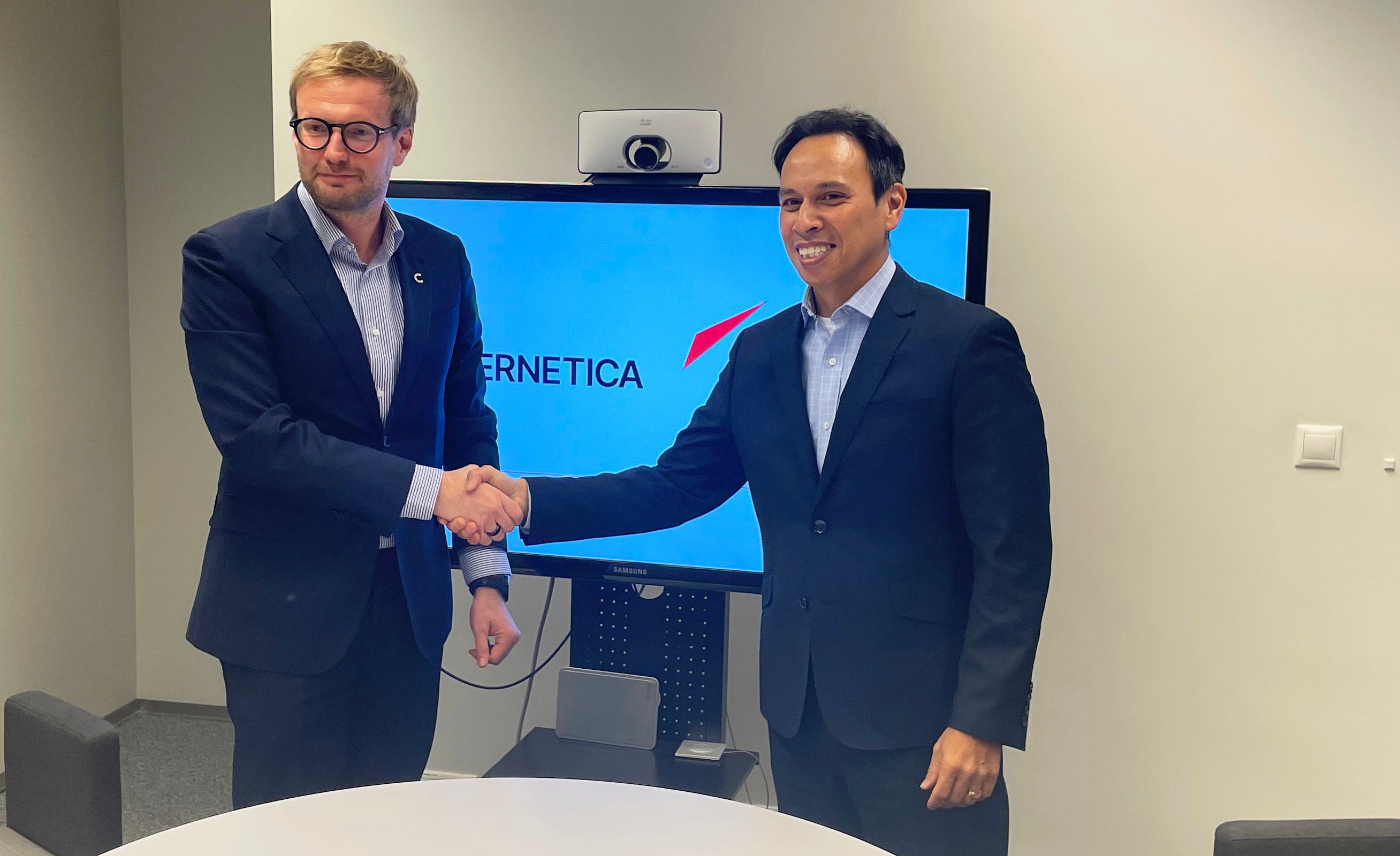 Daniel Verret, Adacel CEO and Oliver Väärtnõu, CEO at Cybernetica, shaking hands after signing agreement in Tallinn, Estonia.jpg