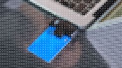 Pixellated image of an ID card inserted into a laptop